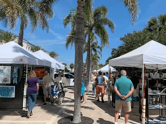 People exploring Art in the Park on a beautiful sunny day in Florida. 