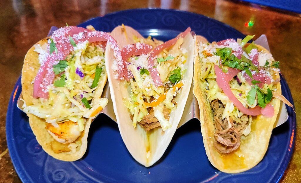 Your choice of tortilla and protein, topped with agave slaw, cotija cheese, and pickled red onions. Foodie Tip: Order the Mango Habanero margarita to go with them! YUM!