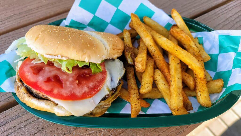 The deluxe cheeseburger at Caseys Place in Vero Beach plated in a basket of fries.