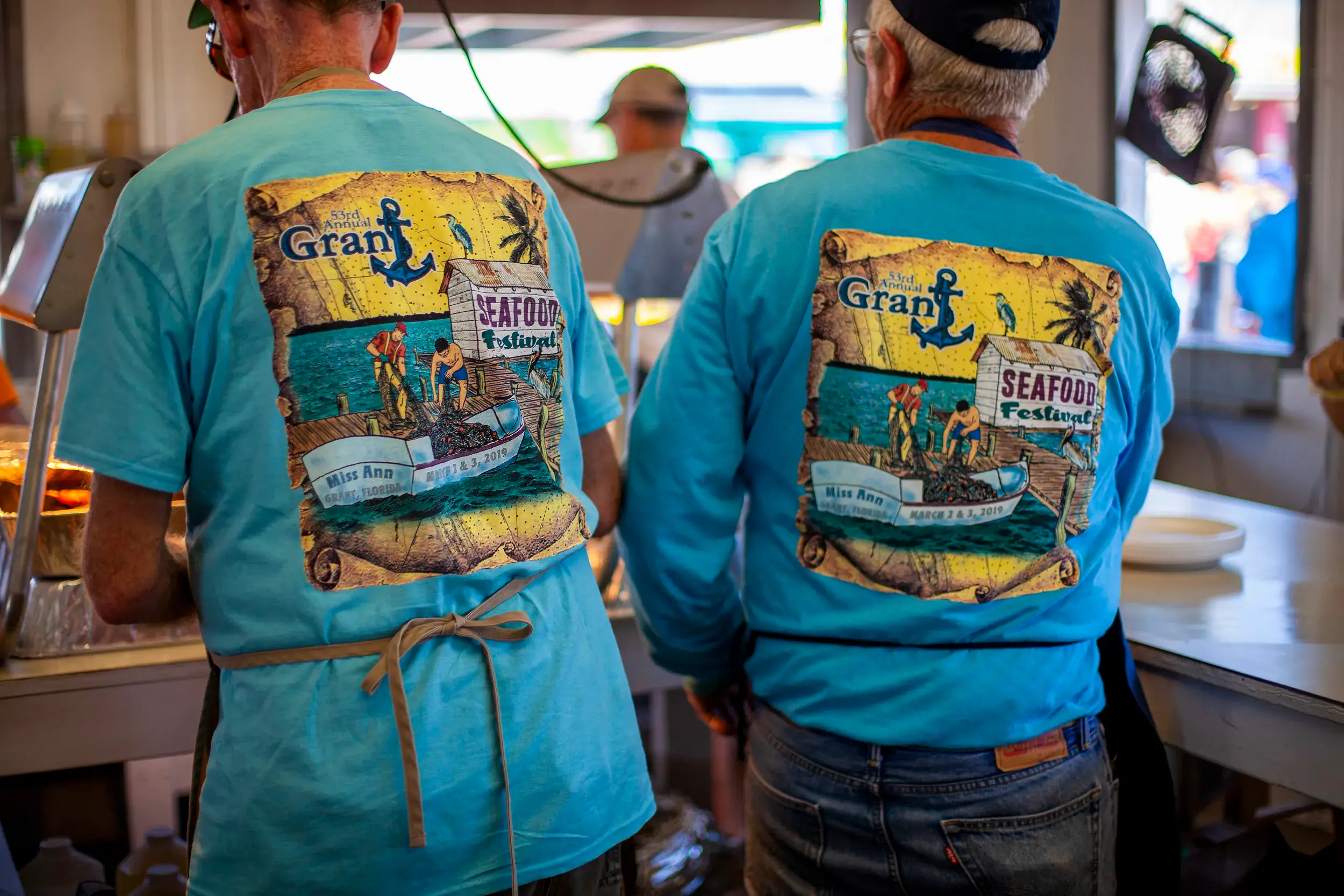 People serving food at the Grant Seafood Festival. 